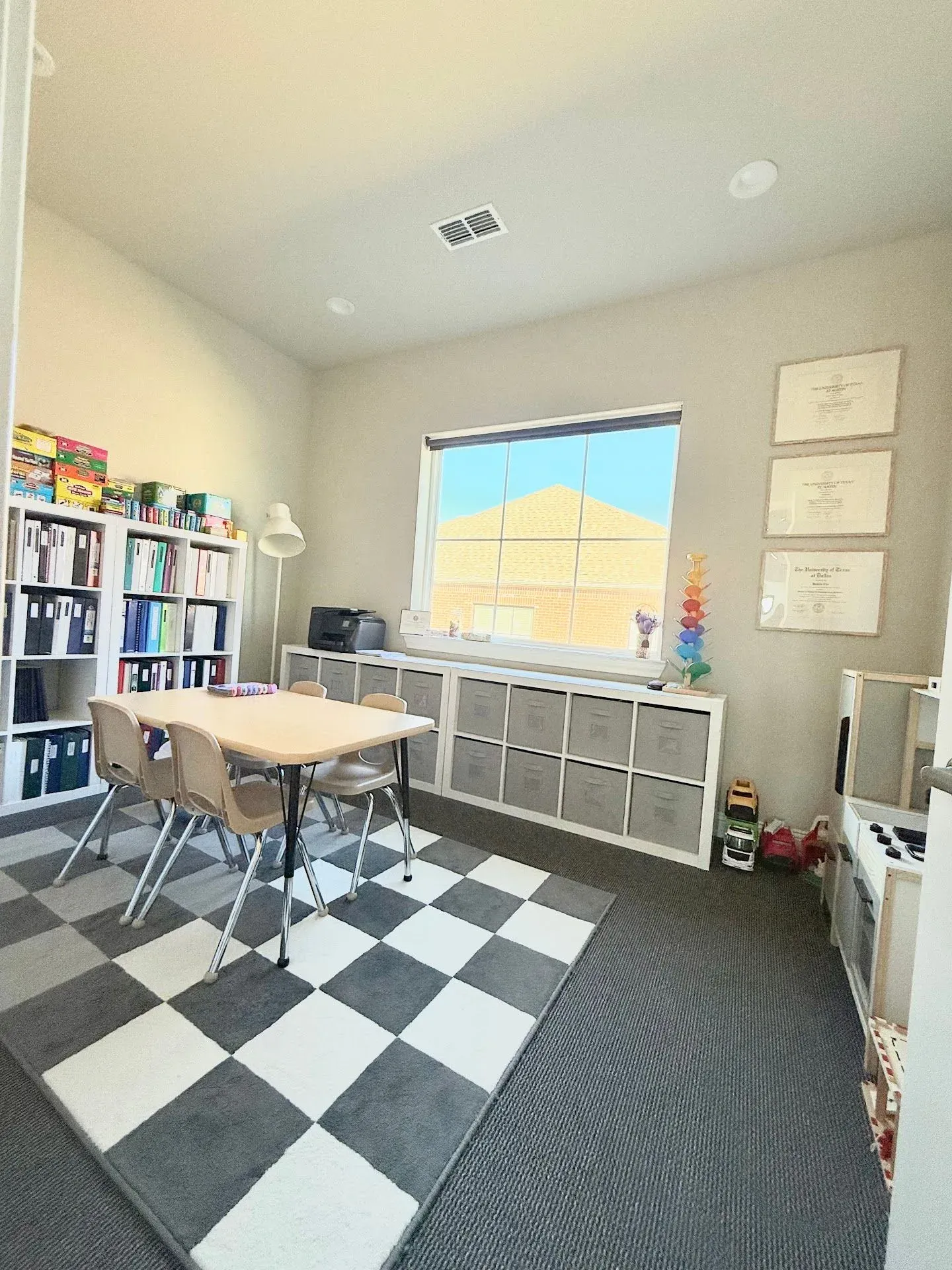 Speech therapy treatment room with ASHA credentials and therapy materials at Jars of Play
